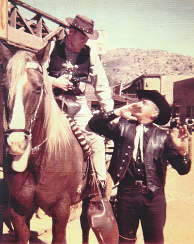 Lee Diebold on Crash Corrigan's horse holding a gun on Cory Rodgers at Corriganville in 1958
